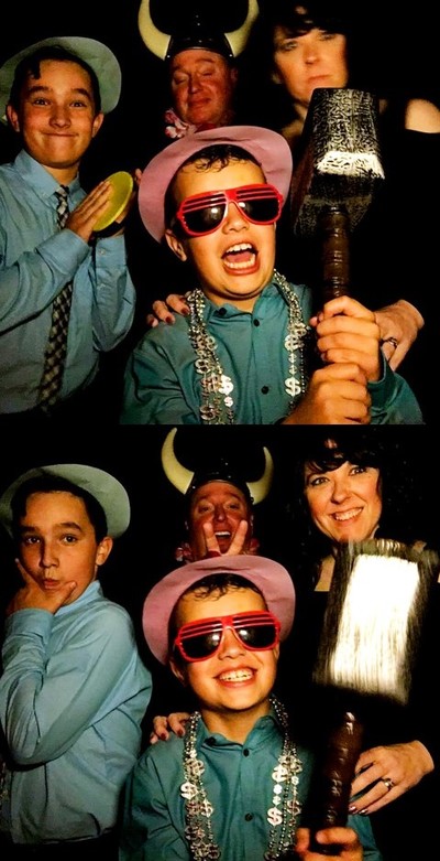 A clip from a photo booth strip showing four people hamming it up for the camera.